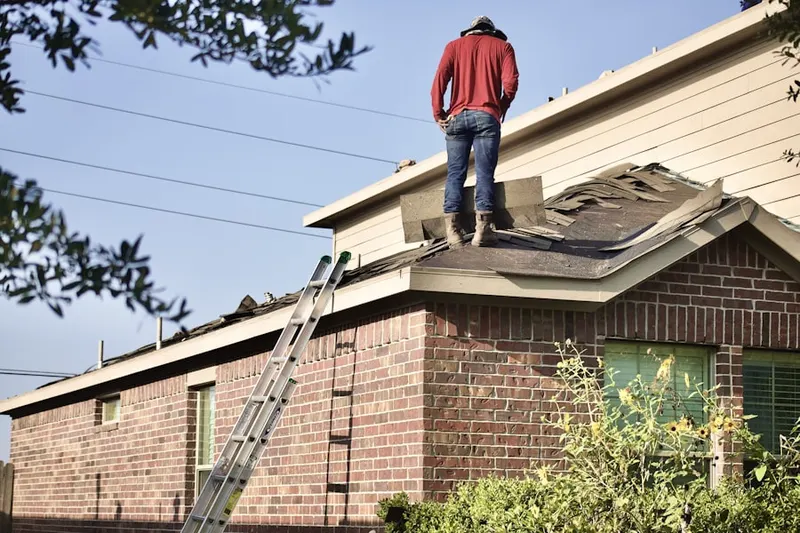 Professional roofer working on a residential roof in Bent Tree West